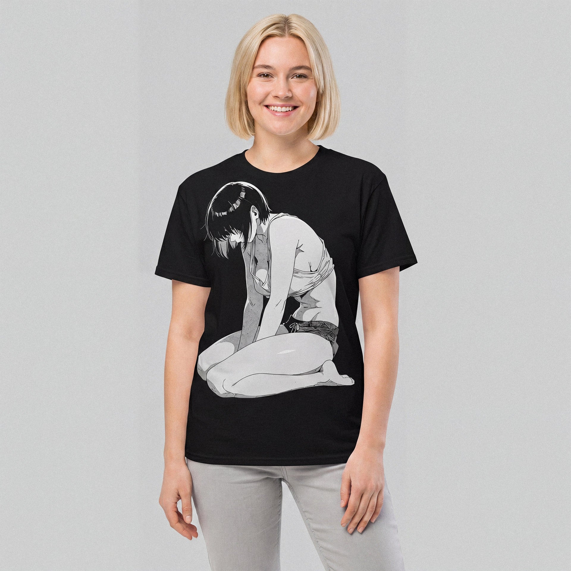 Person wearing a black t-shirt with a graphic design on a plain background