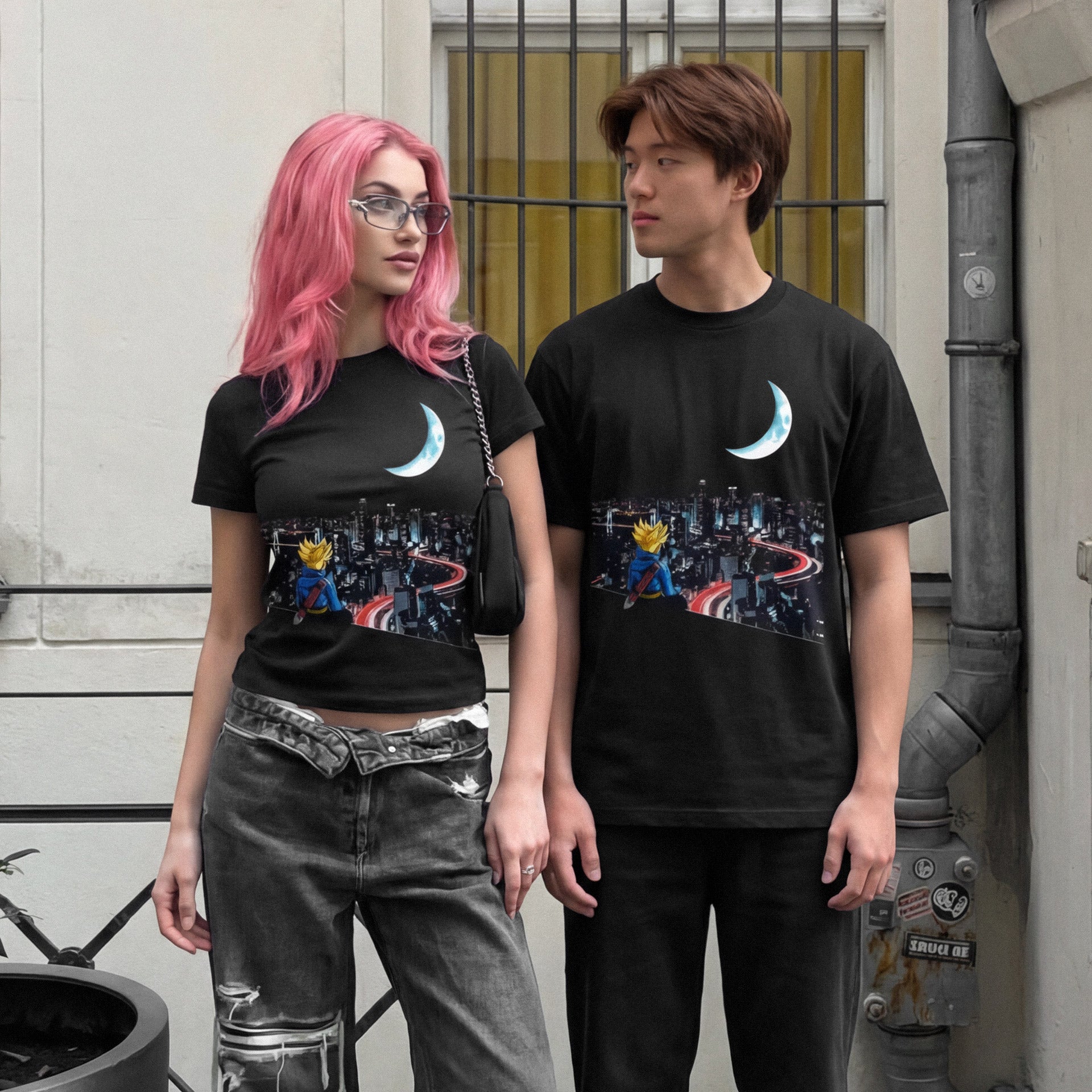 Two people wearing black t-shirts with a cityscape design standing against a building.
