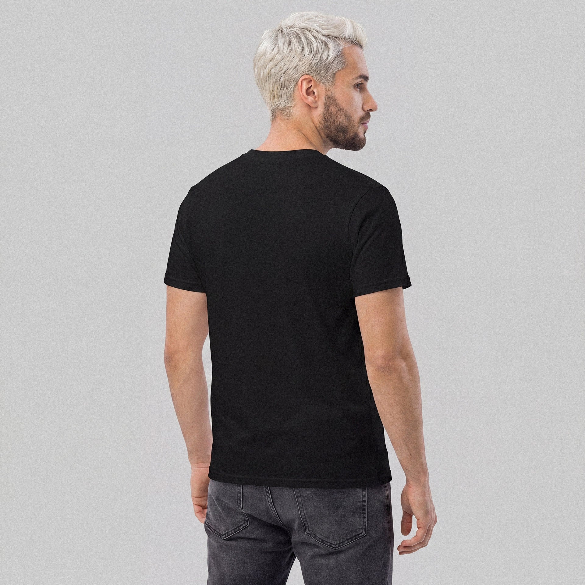 Man wearing a black t-shirt on a gray background