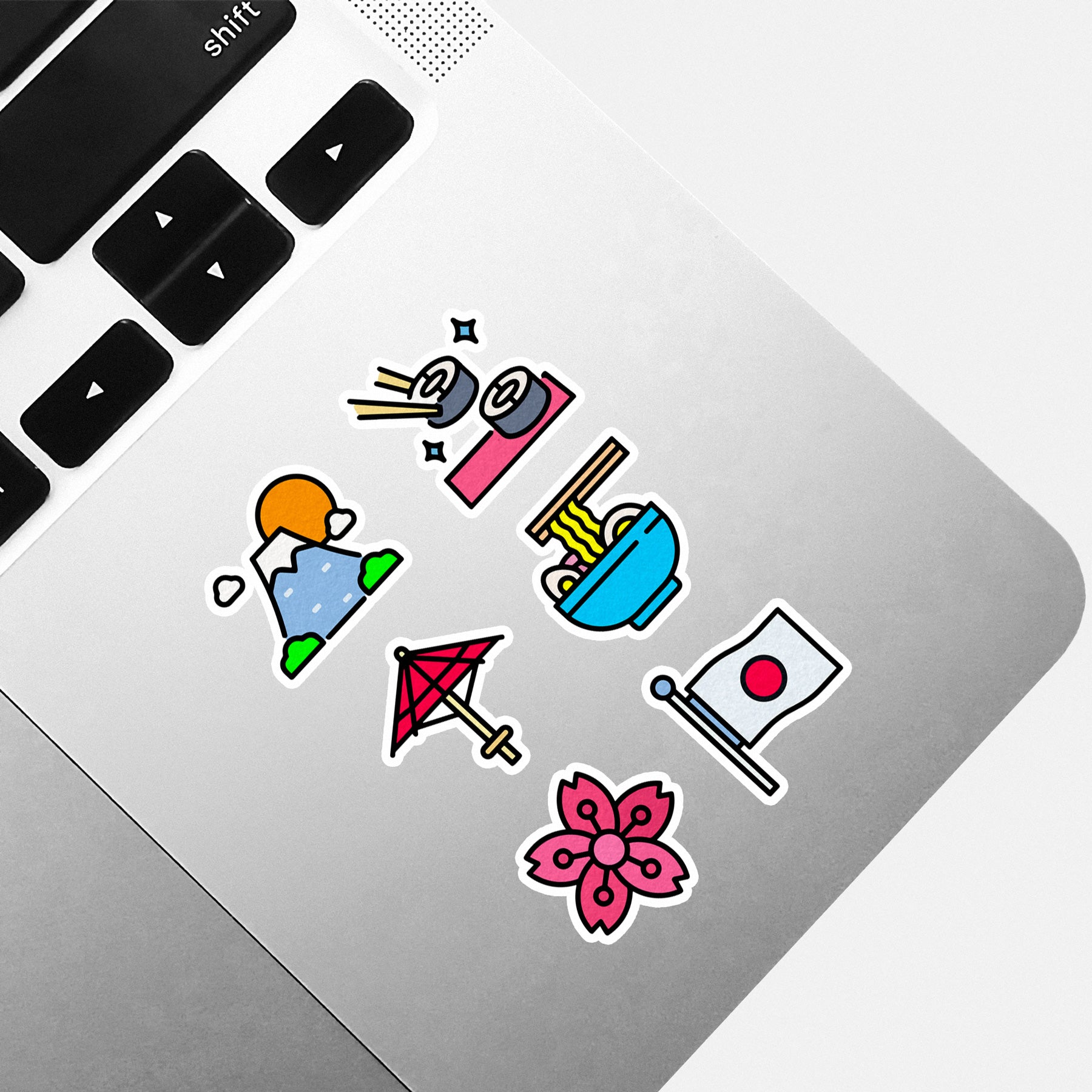 Colorful stickers on a laptop keyboard Japan Tokyo Arkade Official Anime Apparel