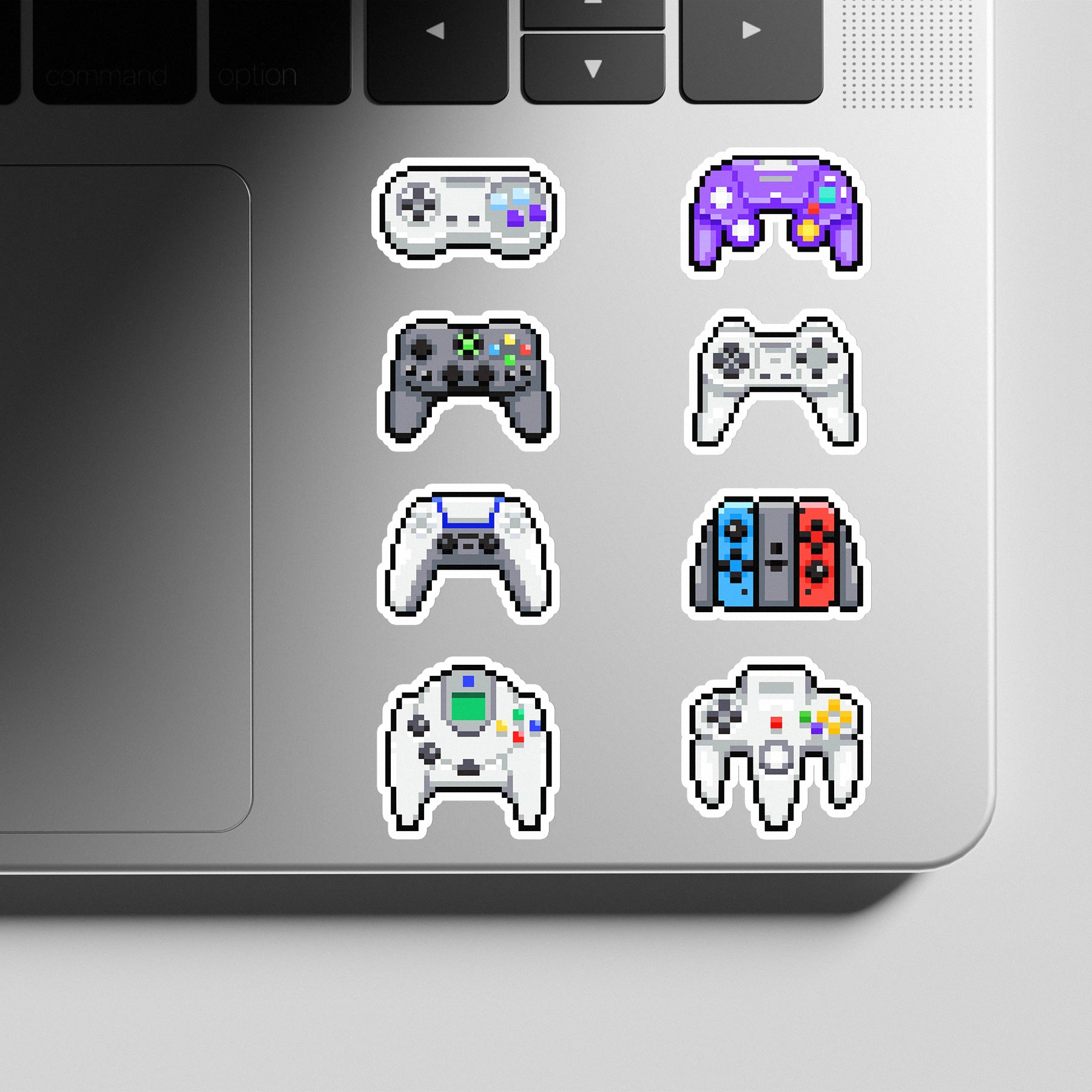 Laptop with various gaming controller stickers on the palm rest area