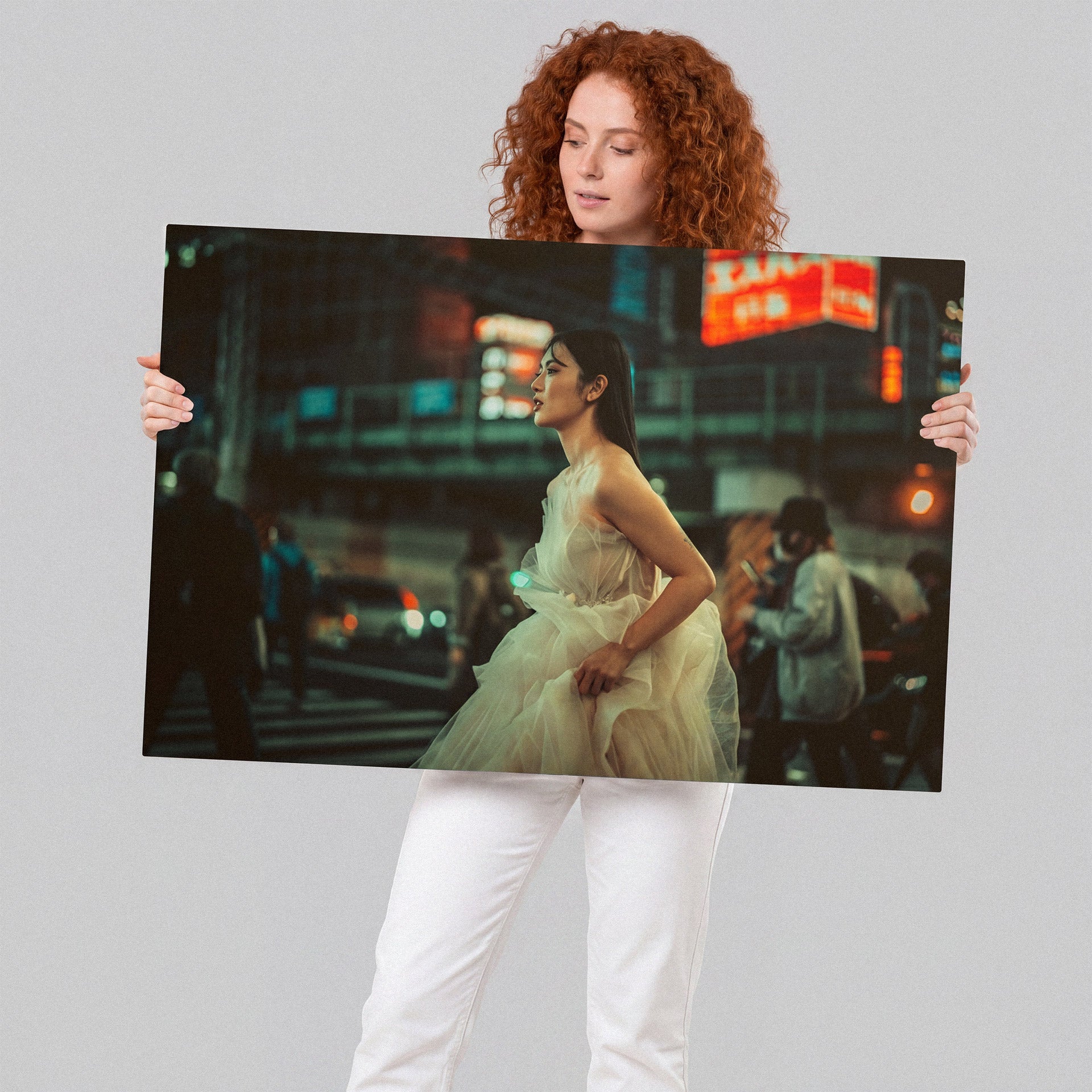 Woman holding a large photo of a woman in a city street at night. anime manga yuna