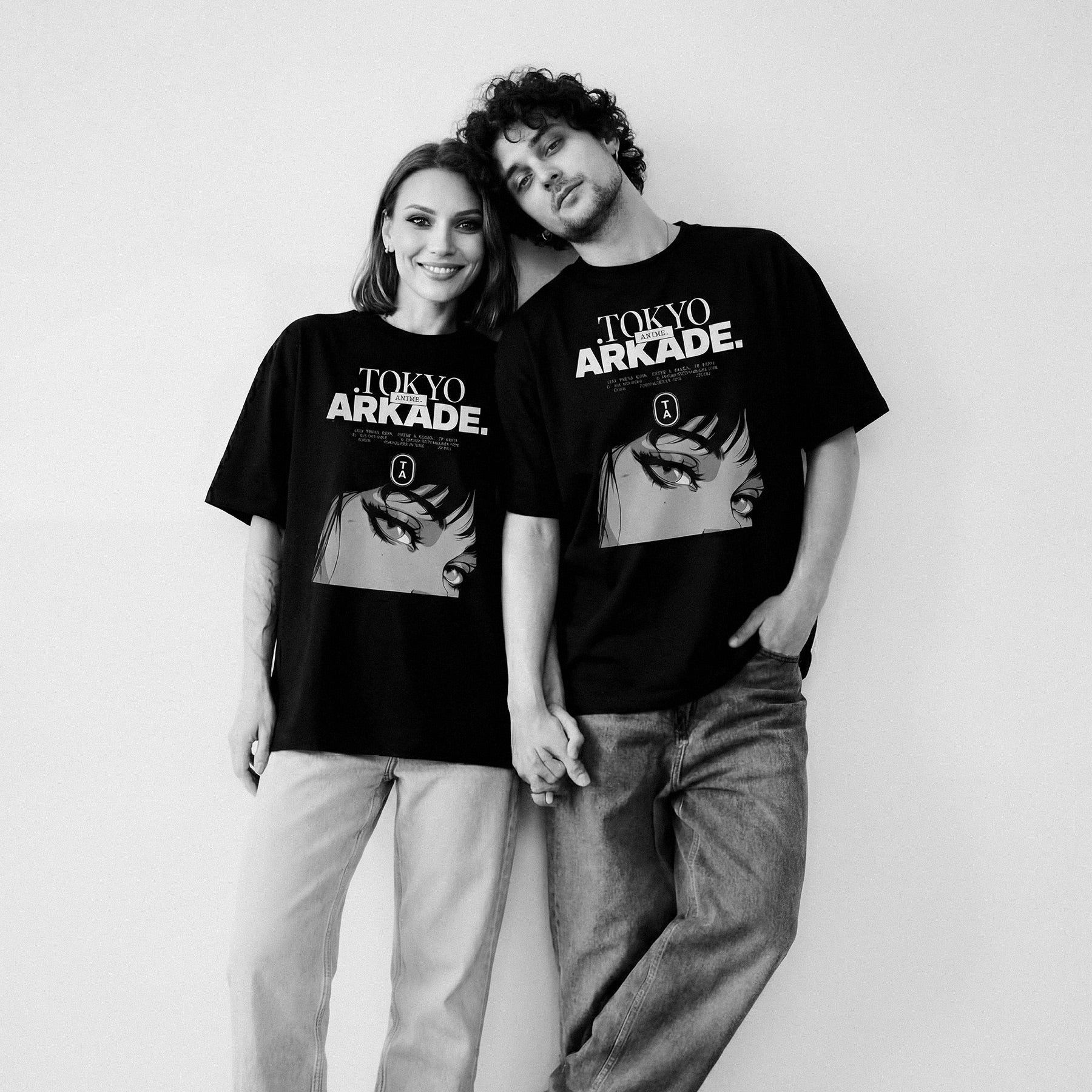 Two people wearing 'Tokyo Arkade' t-shirts against a white background animes invierno 2026, animes primavera 2026, calendario anime 2026, próximos animes estreno, anime más visto 2026, ranking animes 2026, anime doblado al español, anime latino online, anime sub español HD, dónde ver anime legal, plataformas para ver anime, mejores openings anime, mejores endings anime, personajes más fuertes del anime, top protagonistas anime, villanos más poderosos anime, anime isekai recomendado, mejores animes shonen, a